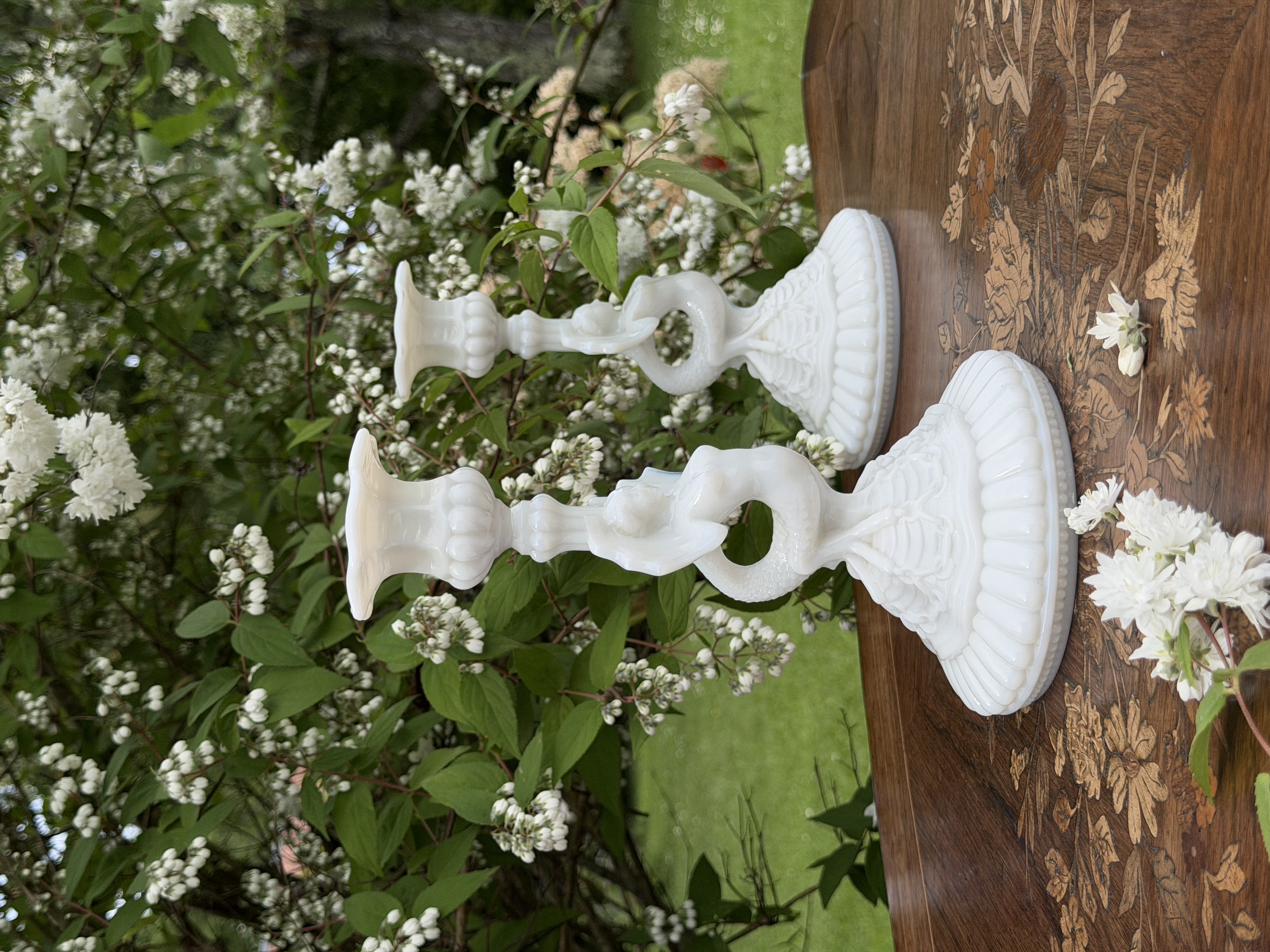 Pair of neo-classical flambeaux against wooden inlay table