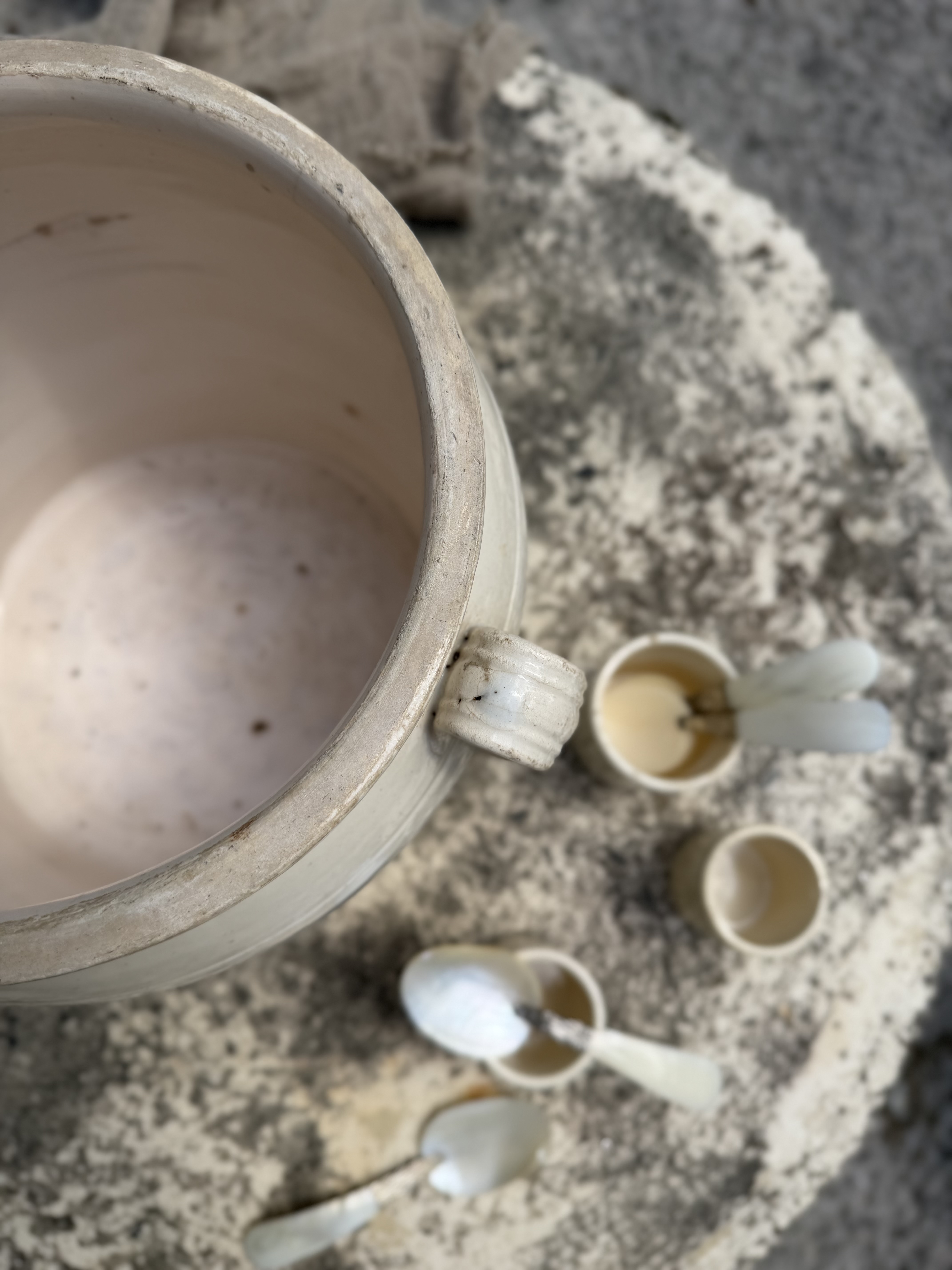 Overhead view into the deep rustic basin of the antique French pot