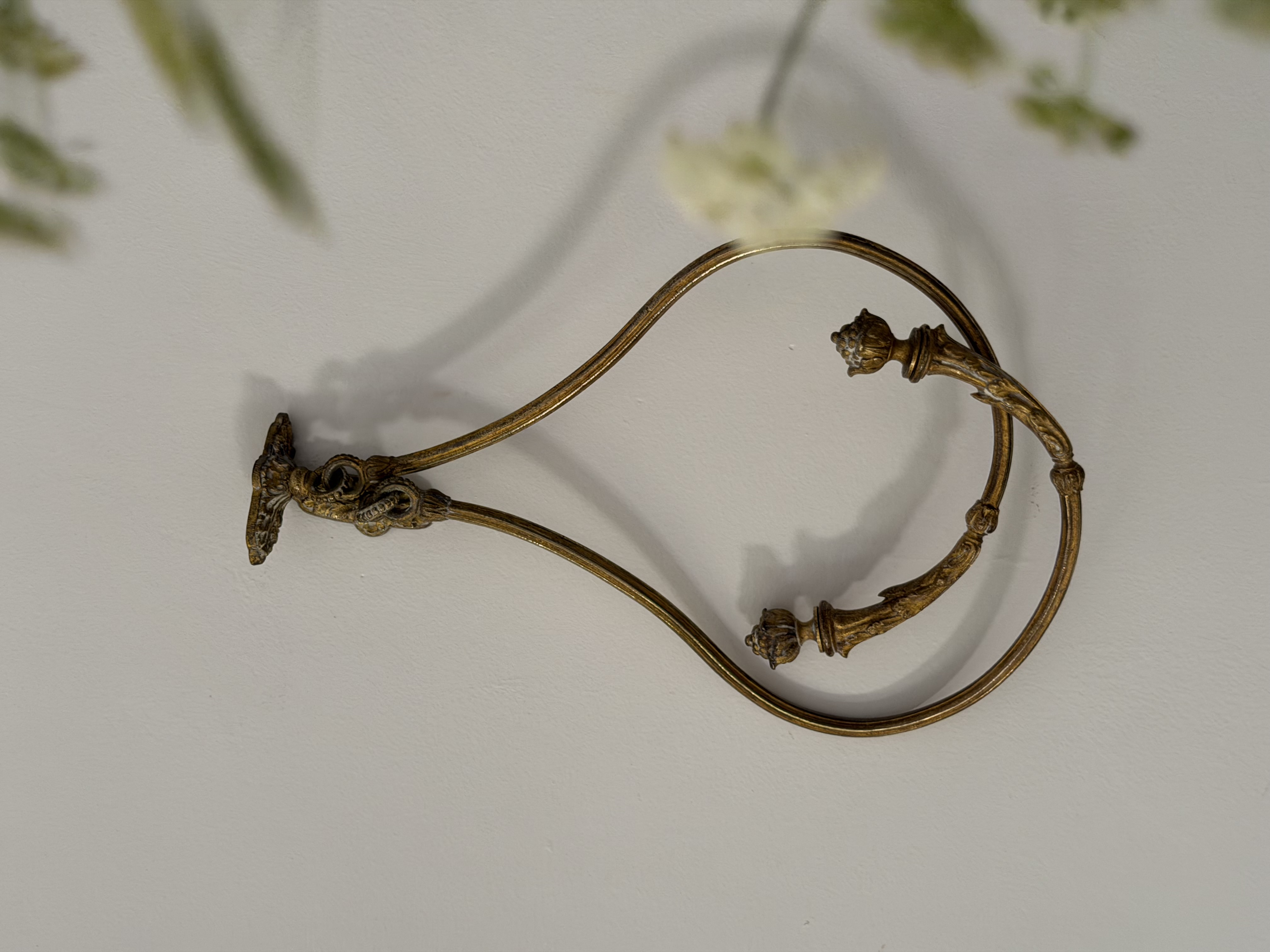 Pair of French bronze embrasses interlocked on a white wall