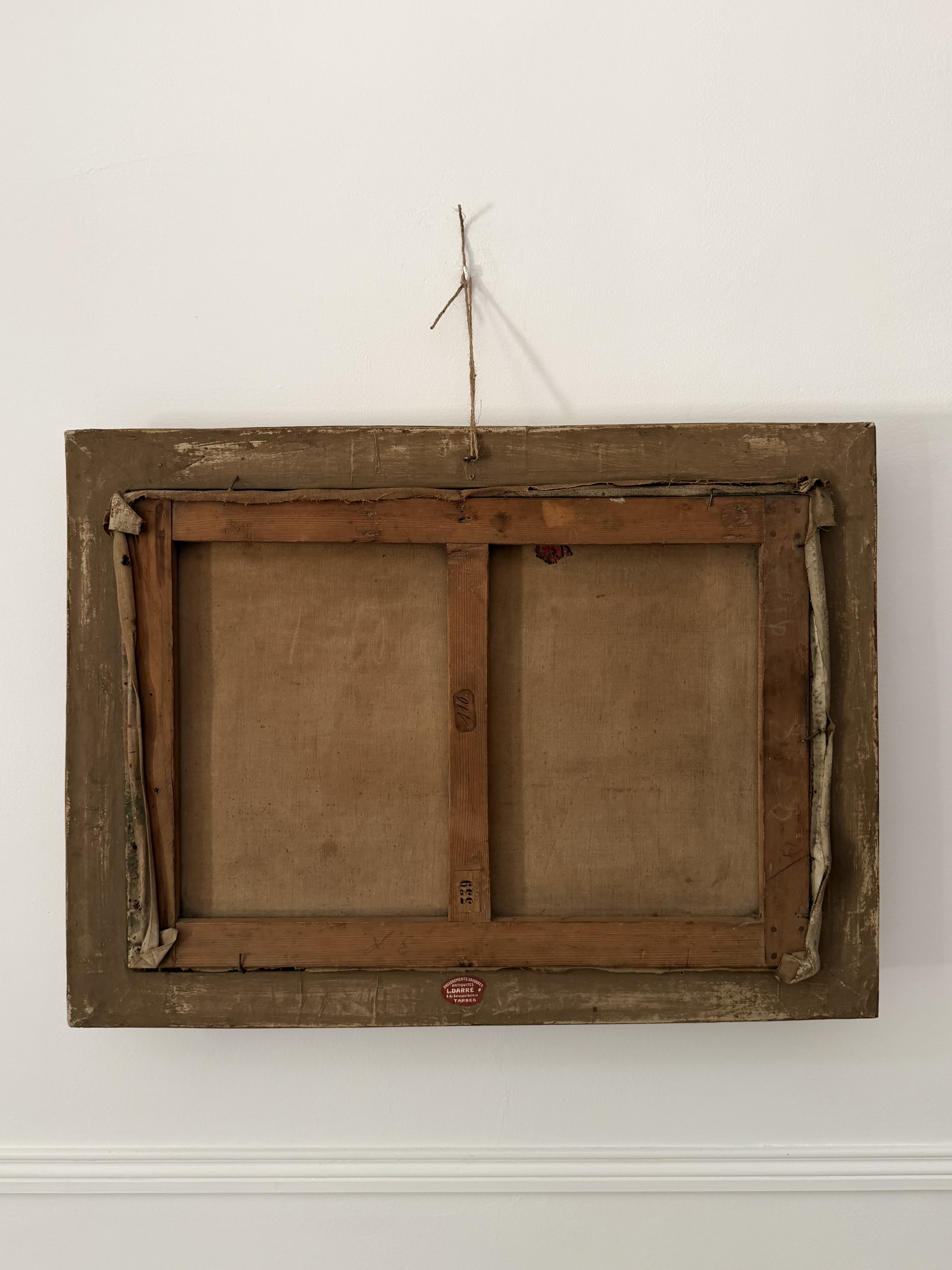 Reverse of the antique oil painting showing canvas stretchers