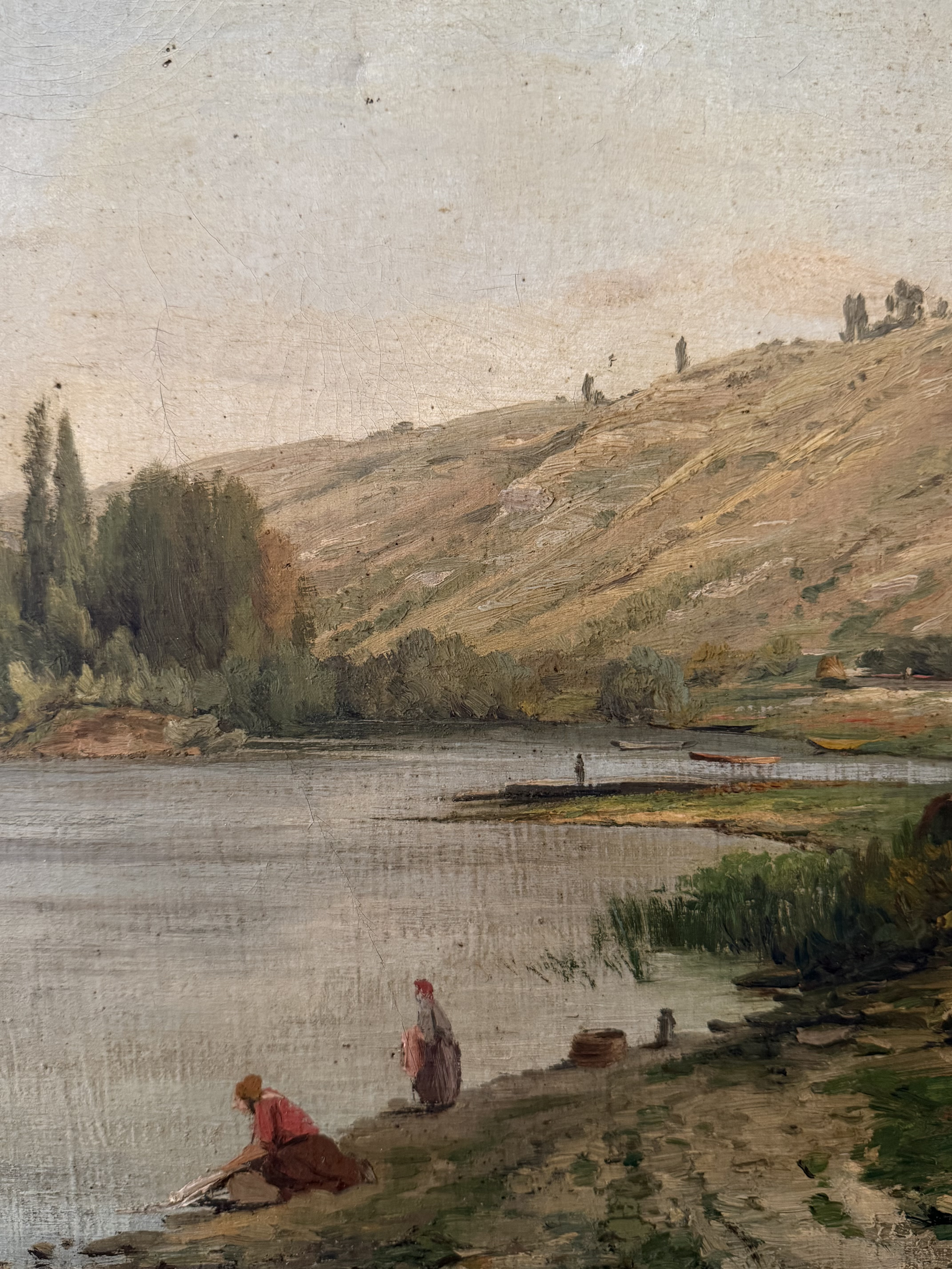 Close up of women washing linens by the river and the artist's signature