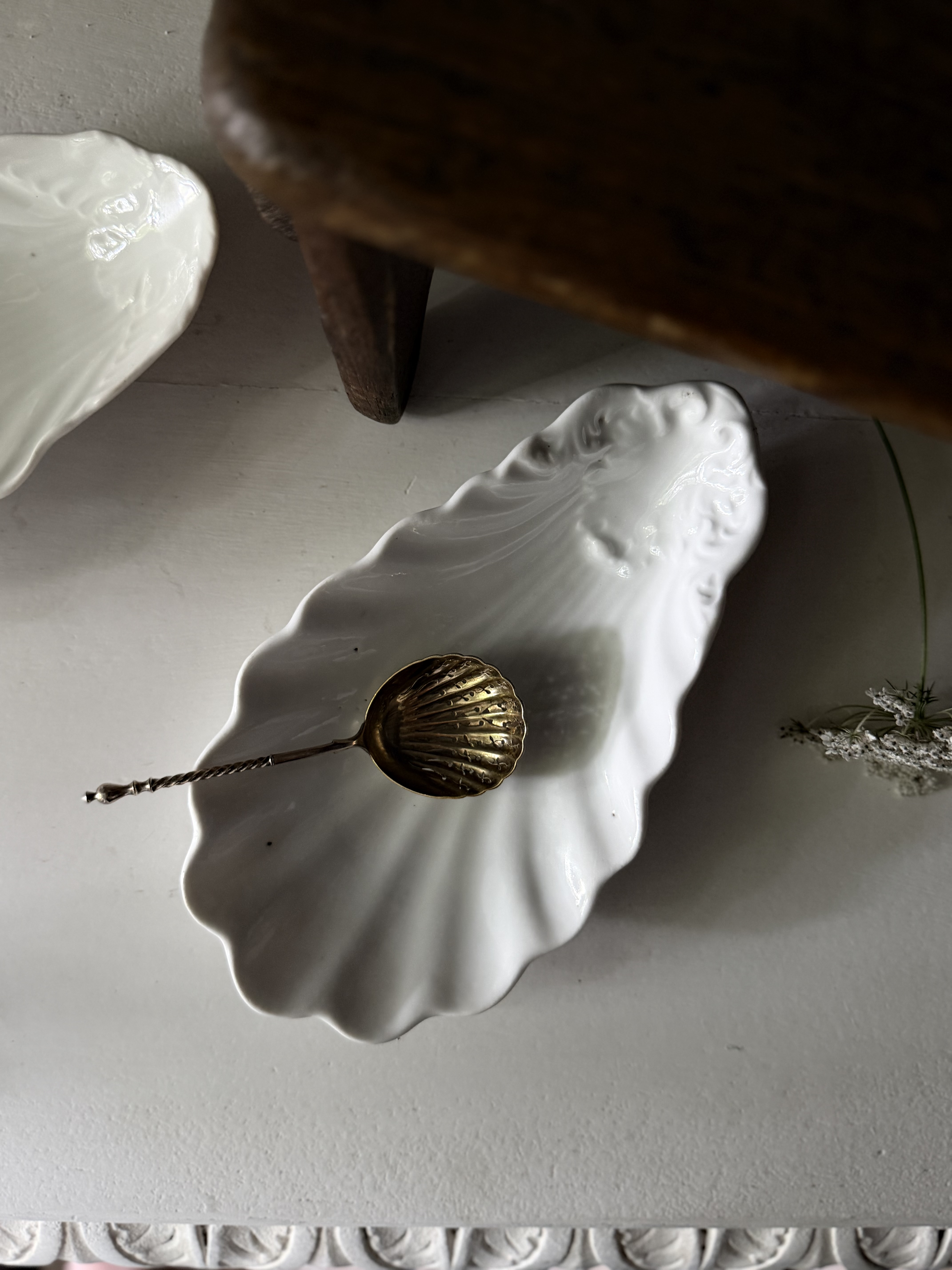 Overhead view of the shell ravier styled with an antique brass spoon