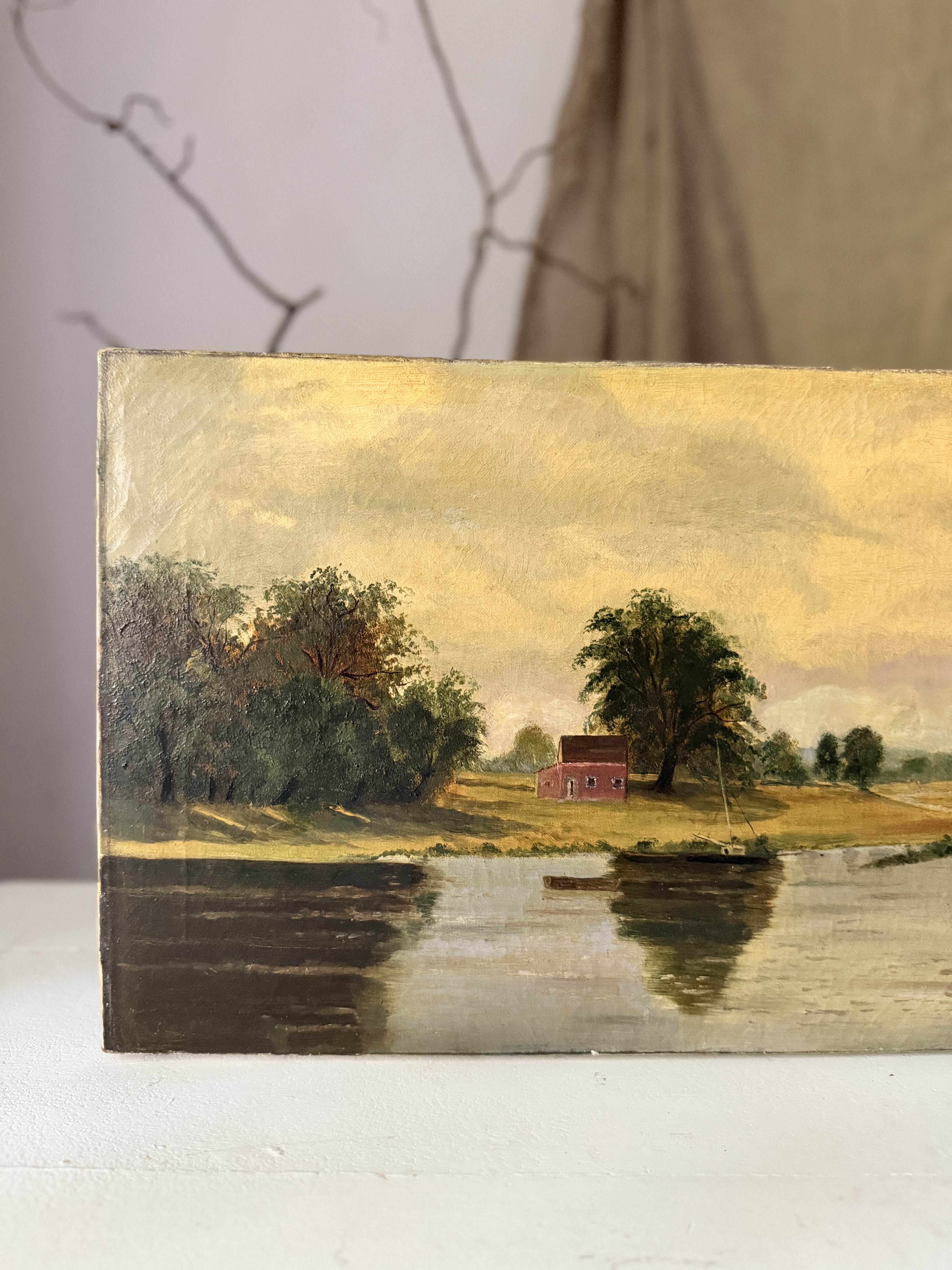 Detail of the antique painting showing a solitary red house and lush trees