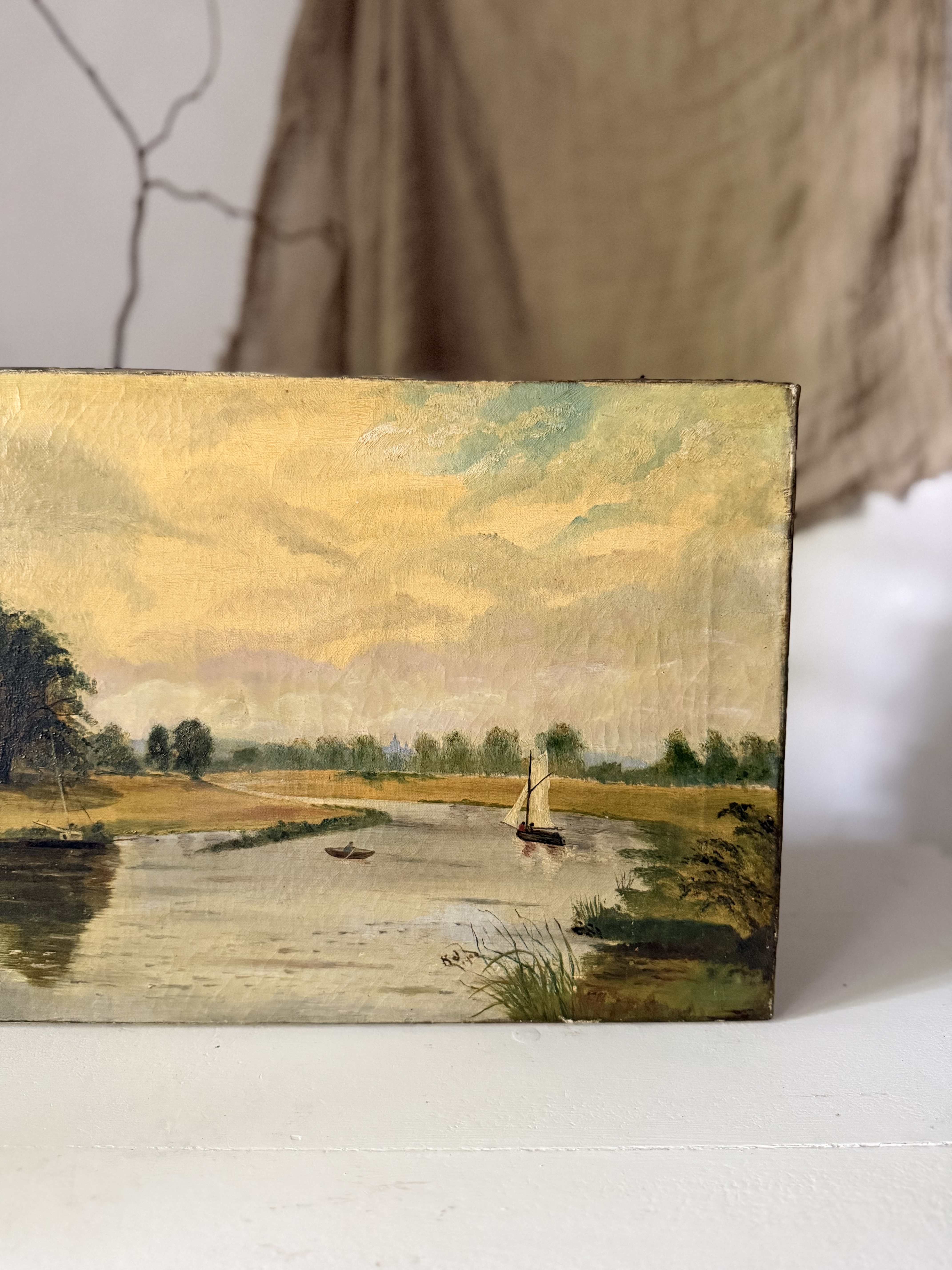 Detail showing a small sailboat drifting along the calm French river