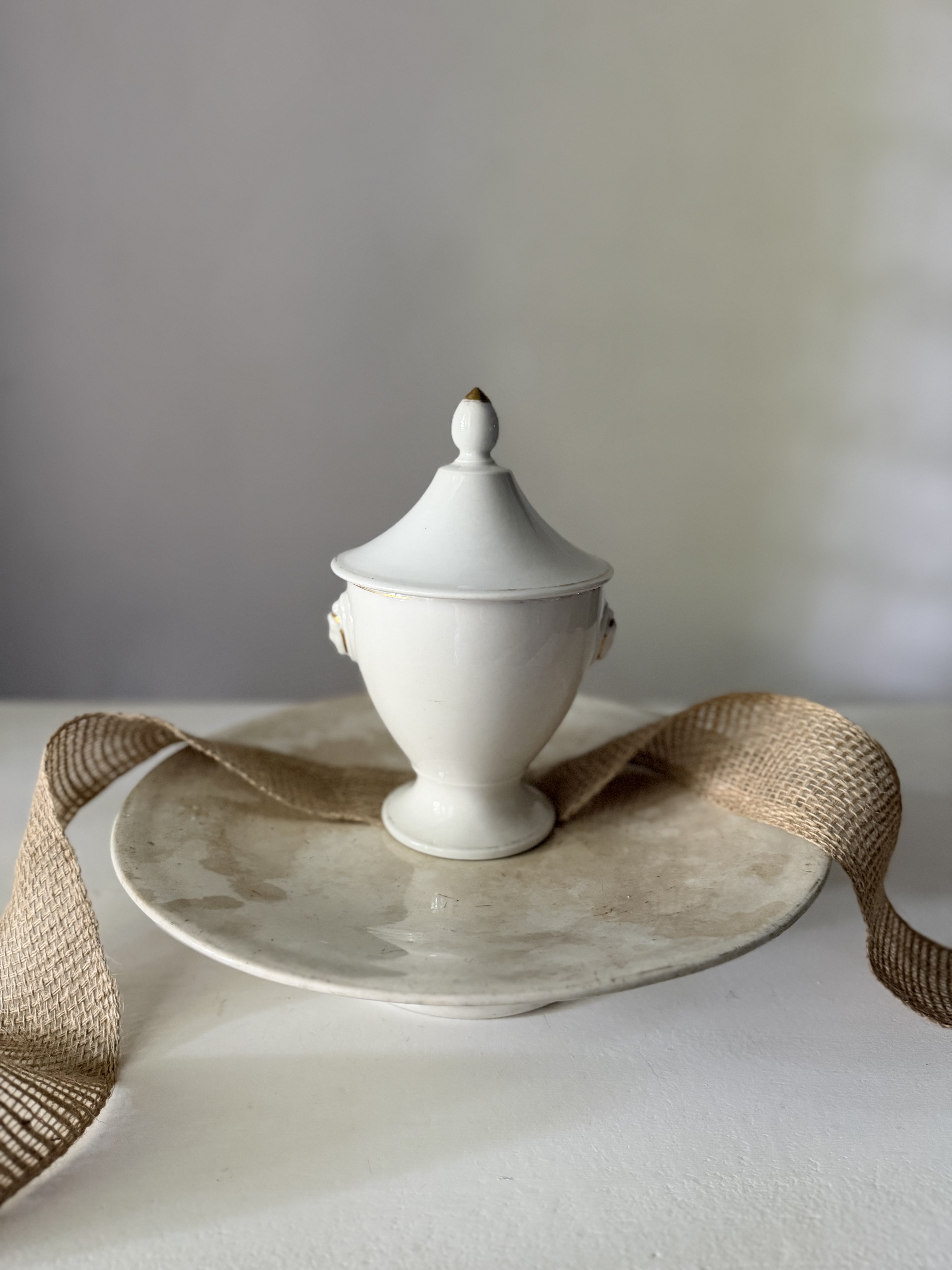 Reverse side of the lidded porcelain dish resting on an antique plate
