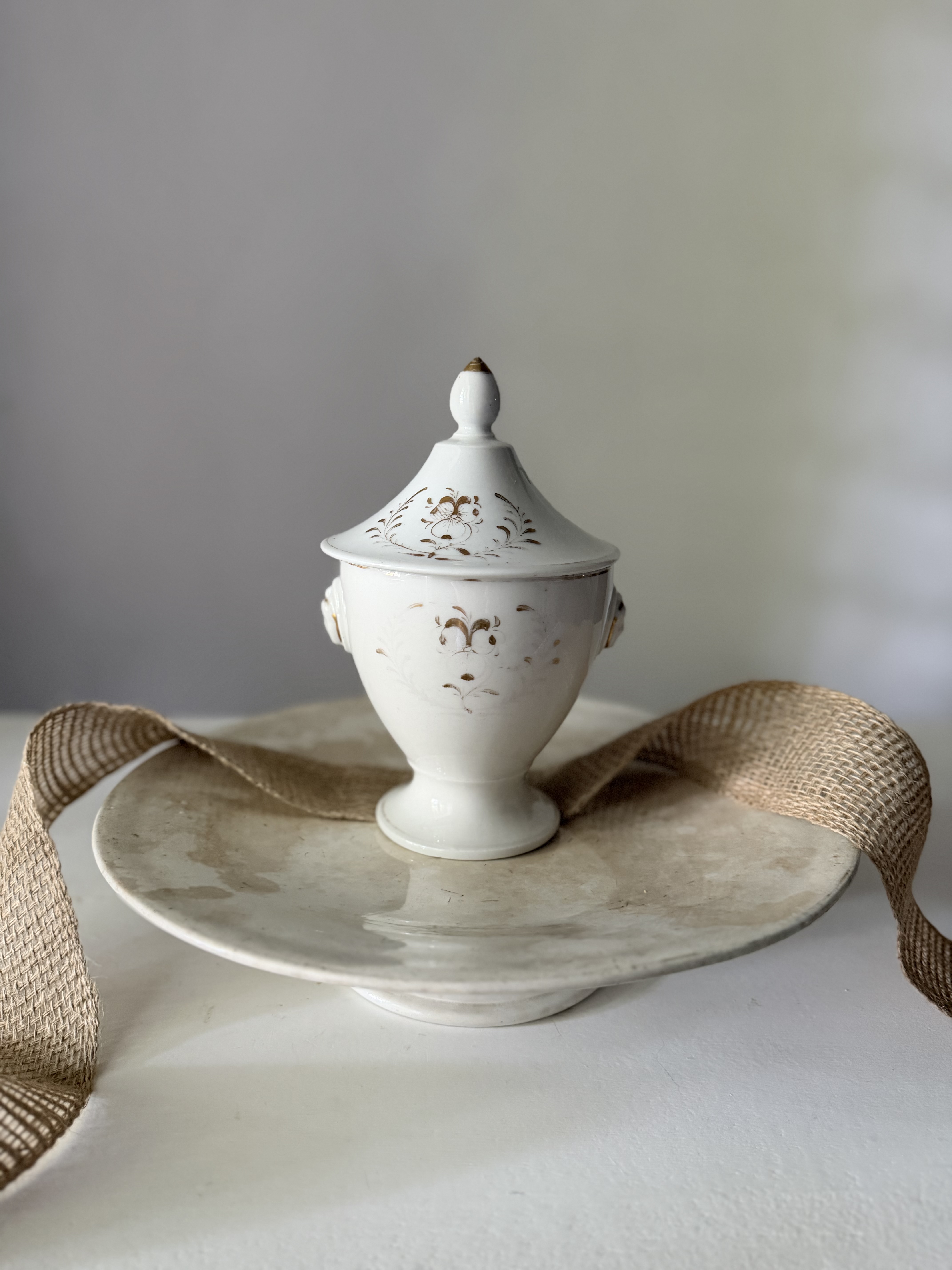 Detail view of the classical molded face motif on the side handle