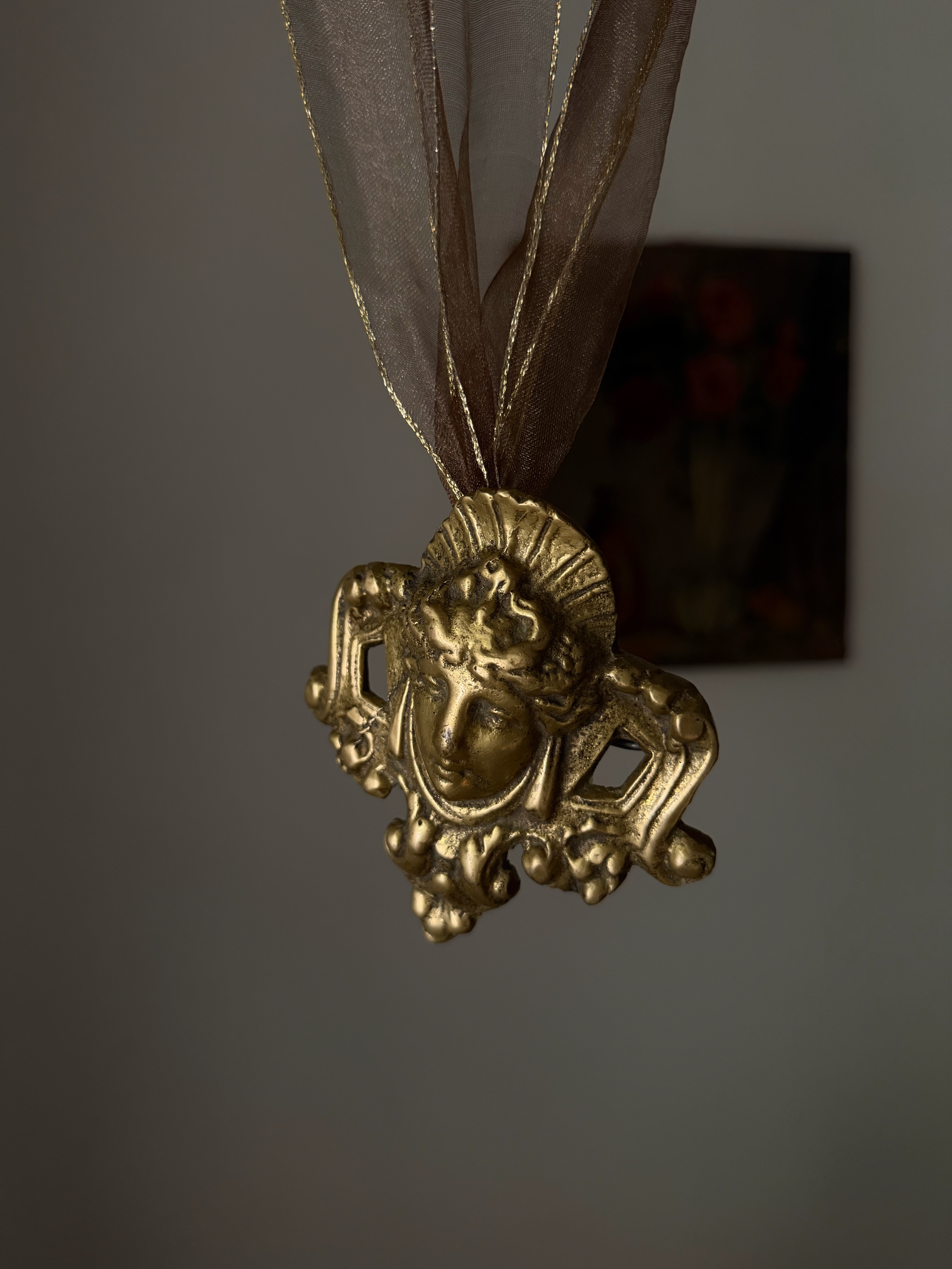 Angled view showing the deep relief of the bronze Rococo casting
