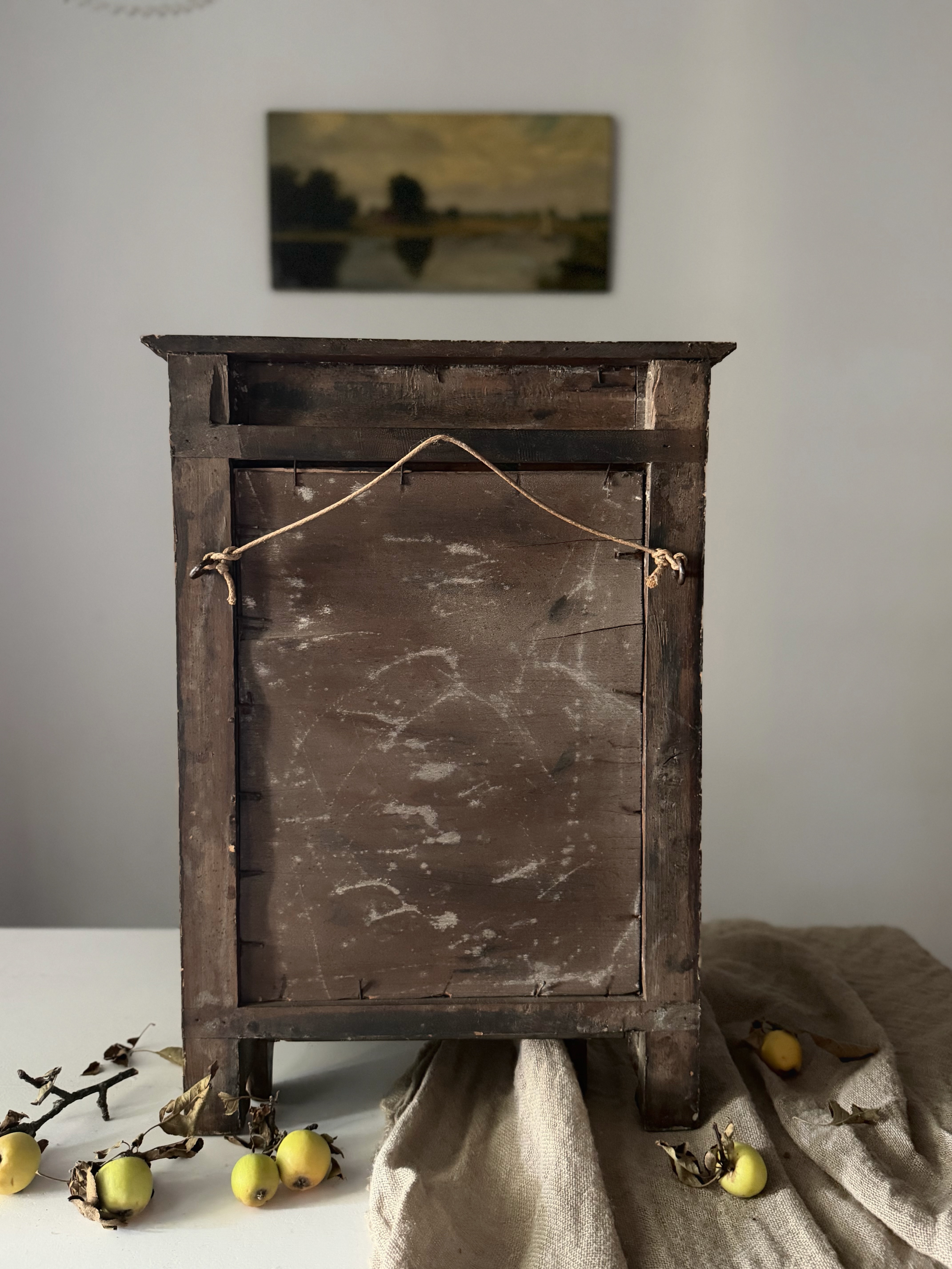 The original primitive wooden backing secured with square-cut iron nails